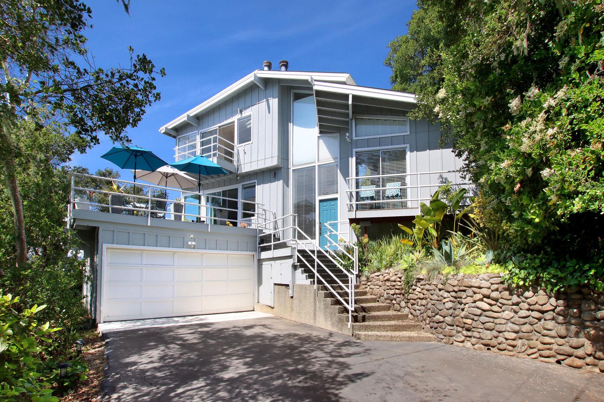 Front elevation of 555 Vista Del Mar Drive with entry stair and sun deck